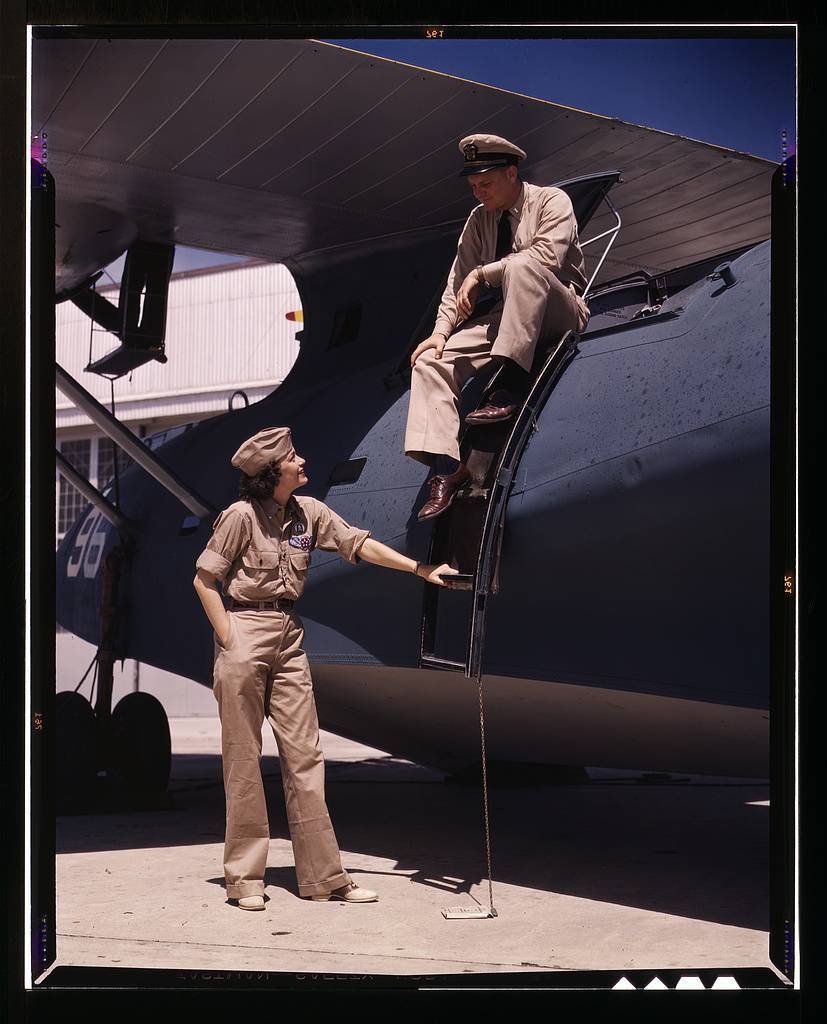 Mrs. Eloise J. Ellis, senior supervisor in the Assembly and Repairs Dept. of the Naval Air Base, talking with one of the men, Corpus Christi, Texas