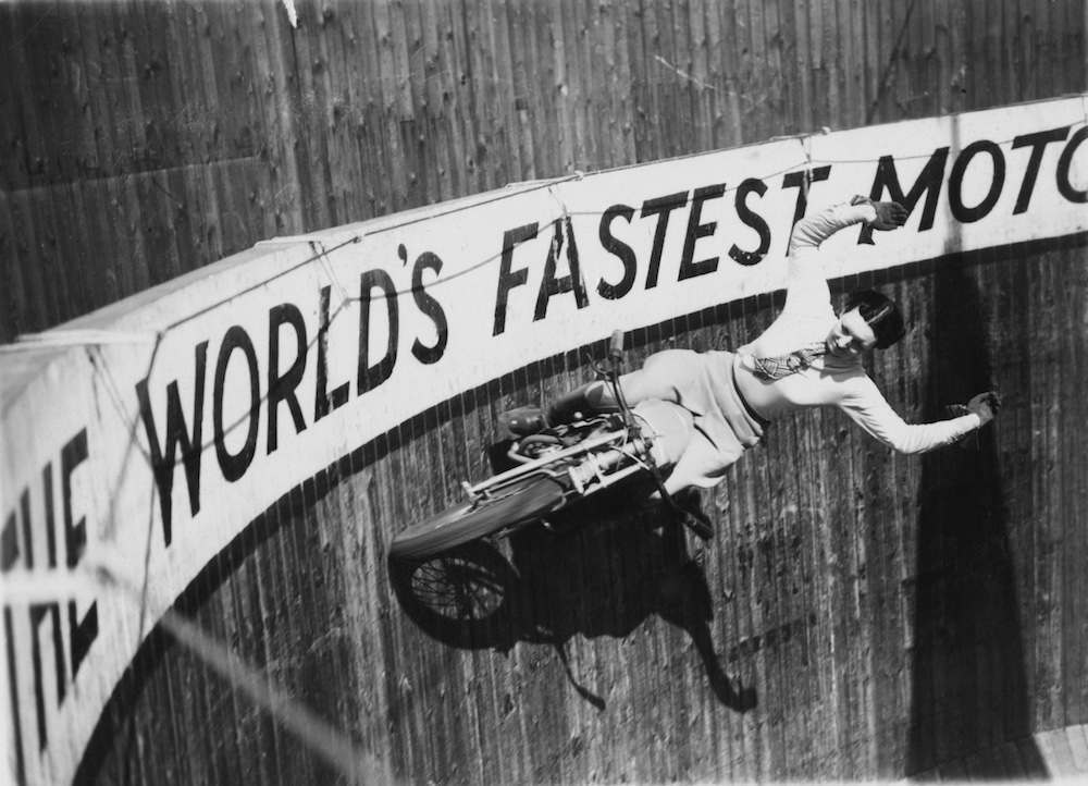 Marjorie Dare (Doris Smith) riding with around 'The Wall of Death' sideshow at the Kursaal amusement park in Southend, Essex, 1938. (Photo by Fox Photos/Hulton Archive/Getty Images)