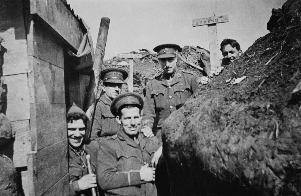 British officers in a trench, probably in Belgium, during World War I, circa 1915. The two signs behind them read 'Piccadilly' and 'The Strand'. (Photo by Topical Press Agency/Hulton Archive/Getty Images)