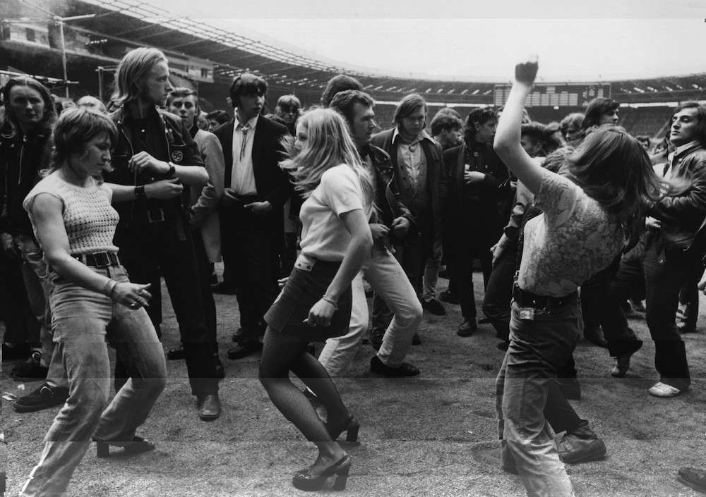 5th August 1972: Three women dancing together during a rock 'n' roll festival at Wembley Stadium. (Photo by Central Press/Getty Images)