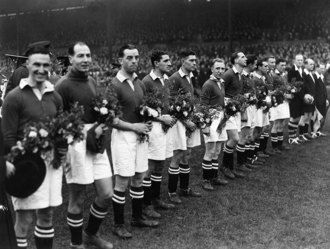 13th November 1945: Chelsea line up at Stamford Bridge with the bouquets of flowers presented to them by the Moscow Dynamo team before their match. (Photo by Topical Press Agency/Getty Images)