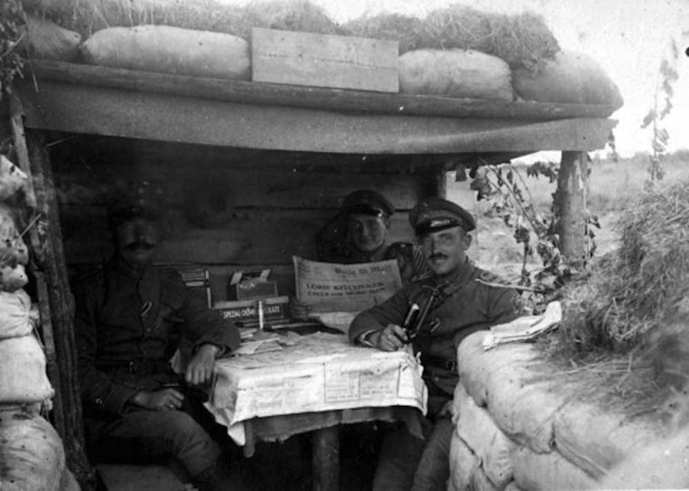 German troops reading “The Daily Mail” in a dugout at Wieltje, East of Ypres, 1915.