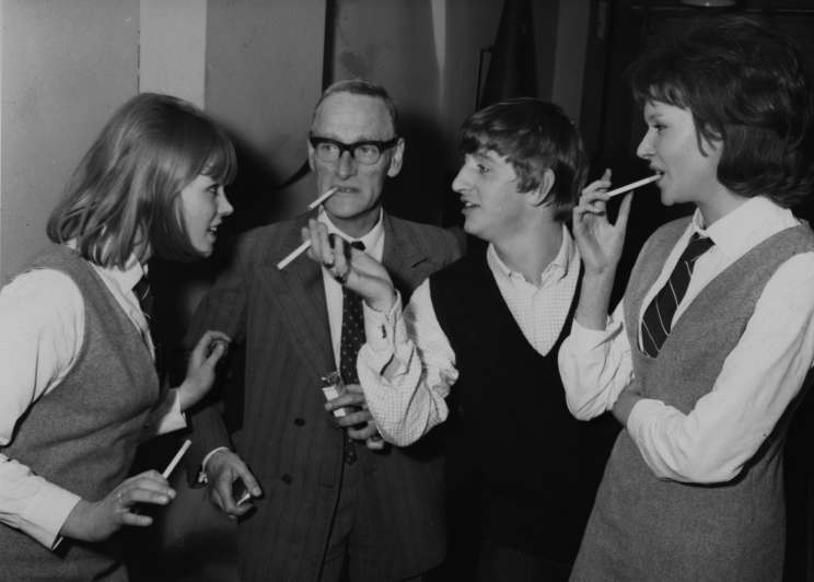 Cigarettes all around as Beatles drummer Ringo Starr, second from right, chats with actress Susan Boyd, left, actor Wilfred Brammel, and Tina Williams on the set of the Beatles first film, (not yet named) at Twickenham Studios, near London, Middlesex, March 12, 1964. EDS note: The movie was later given the title "Yeah! Yeah! Yeah! (AP Photo)