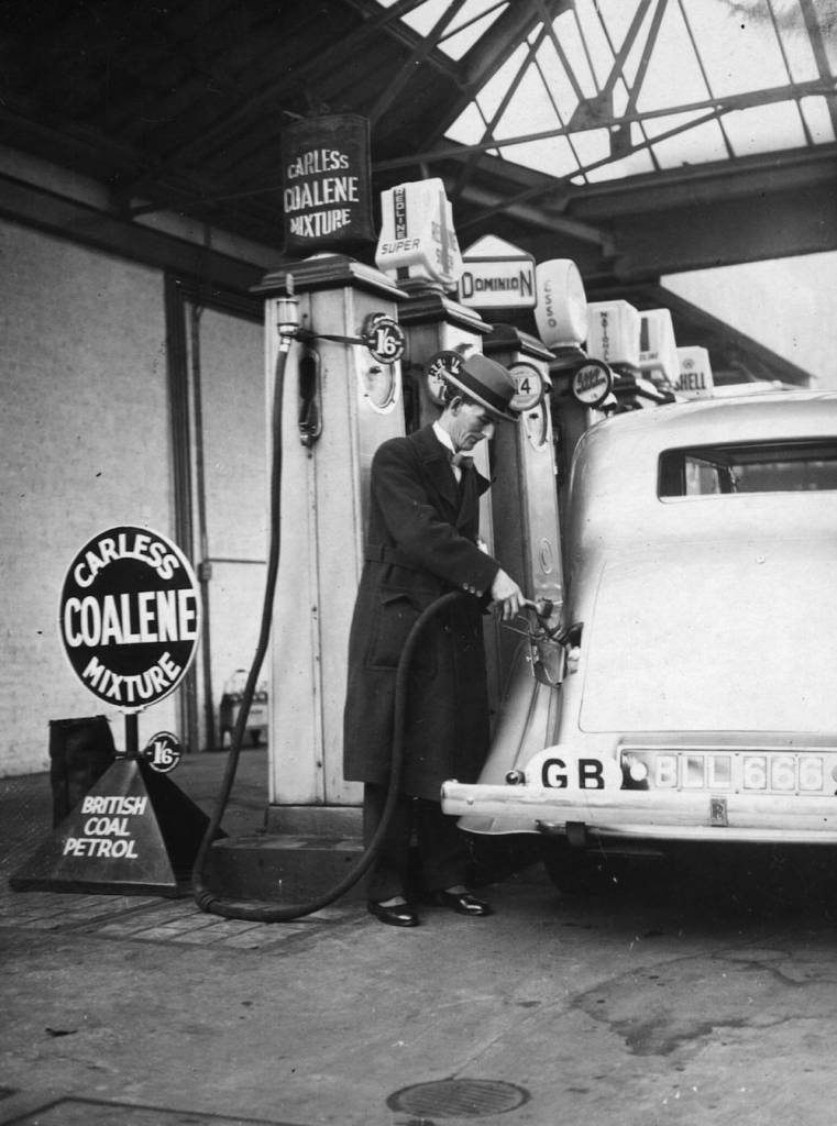 November 1935: Tom Williams, MP for Don Valley, fills up the first car with petrol from British coal at a service station in London. Williams represents the Doncaster miners, who hew the coal from which the petrol is distilled. It is produced by the coalite carbonisation process. (Photo by E. Dean/Topical Press Agency/Getty Images)
