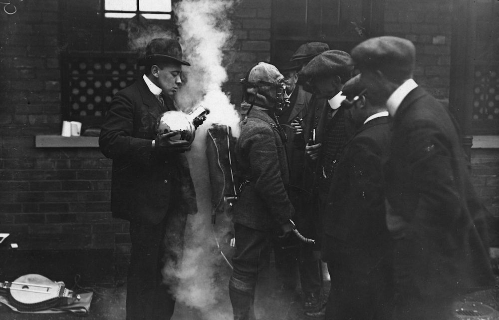 October 1908: Workmen attending a demonstration of Simons safety apparatus, for use in the coal mining industry. (Photo by Topical Press Agency/Getty Images)