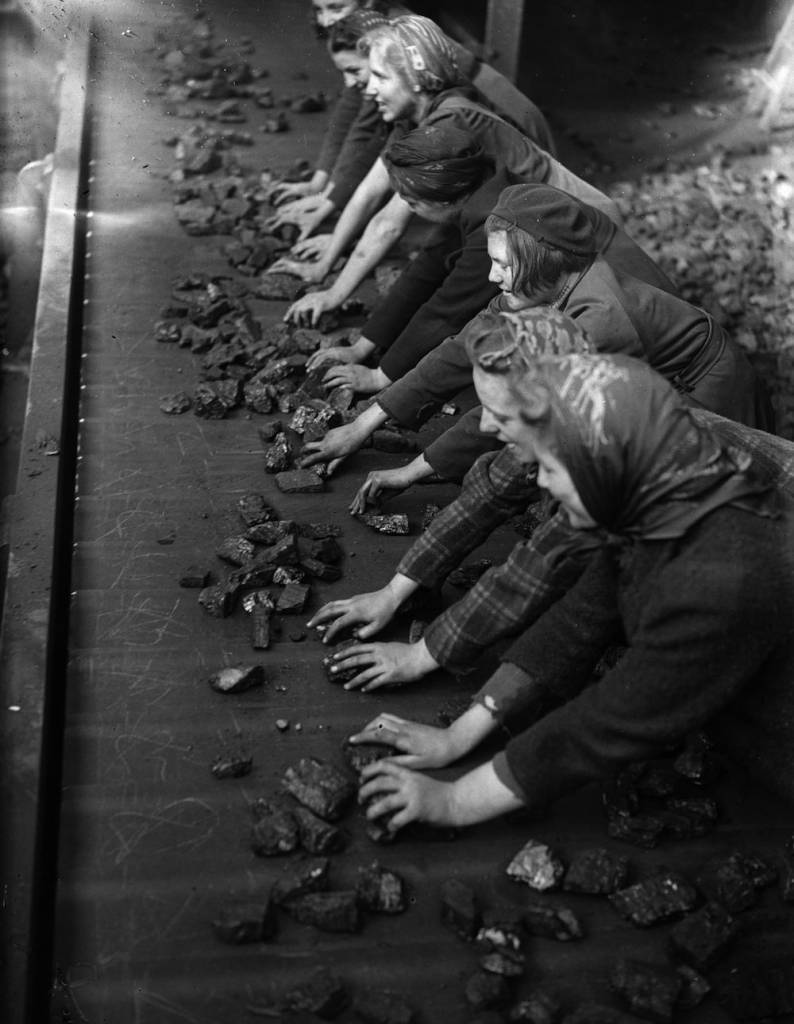 1942: Women sorting coal on a conveyor belt. (Photo by Express/Express/Getty Images)