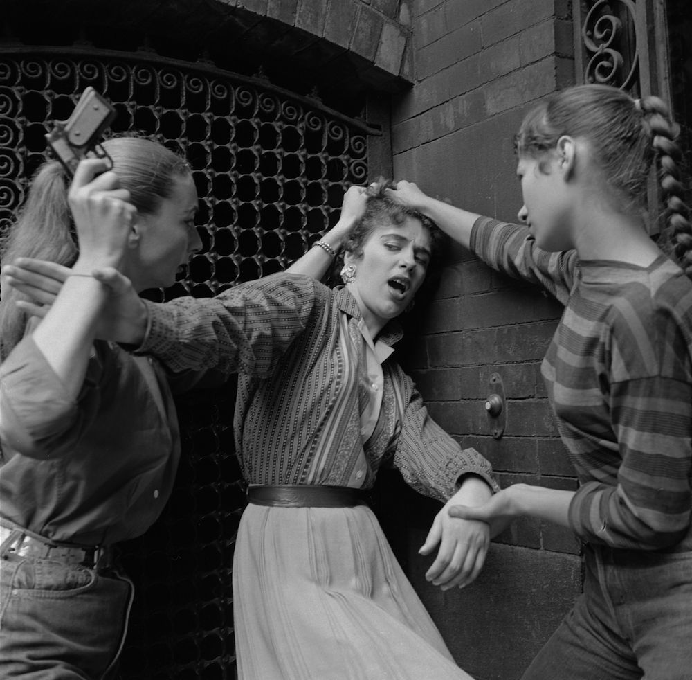 circa 1955: Members of a teenage girl gang convincing an unwilling recruit to join the gang. (Photo by Vecchio/Three Lions/Getty Images)