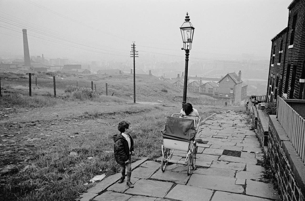 Bradford, 1970 Pushing a pram up an unadopted road