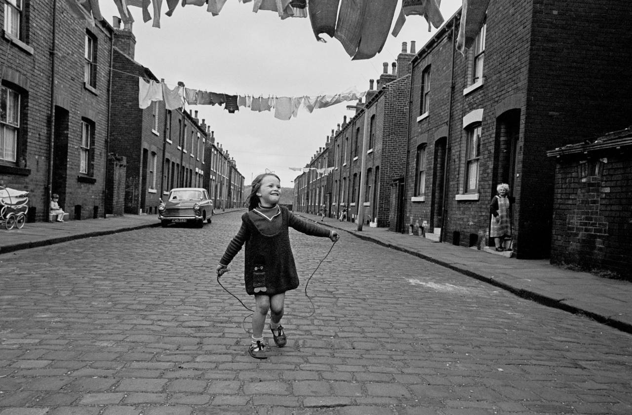 Child skipping in a street of back to backs Leeds 1970