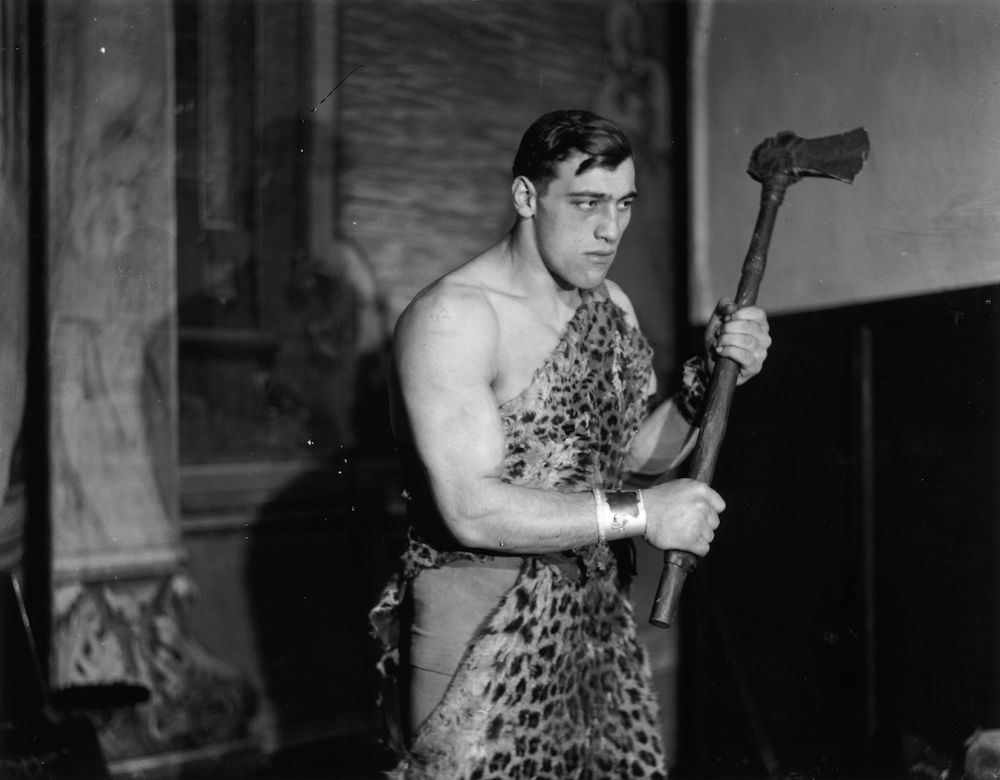 13th December 1929: Primo Carnera (1906 - 1967) the Italian heavyweight boxer and wrestler poses in a leopard skin to represent a cave-man at a 'Joy of Life' Ball at the Royal Opera House, Covent Garden, London. (Photo by Topical Press Agency/Getty Images)