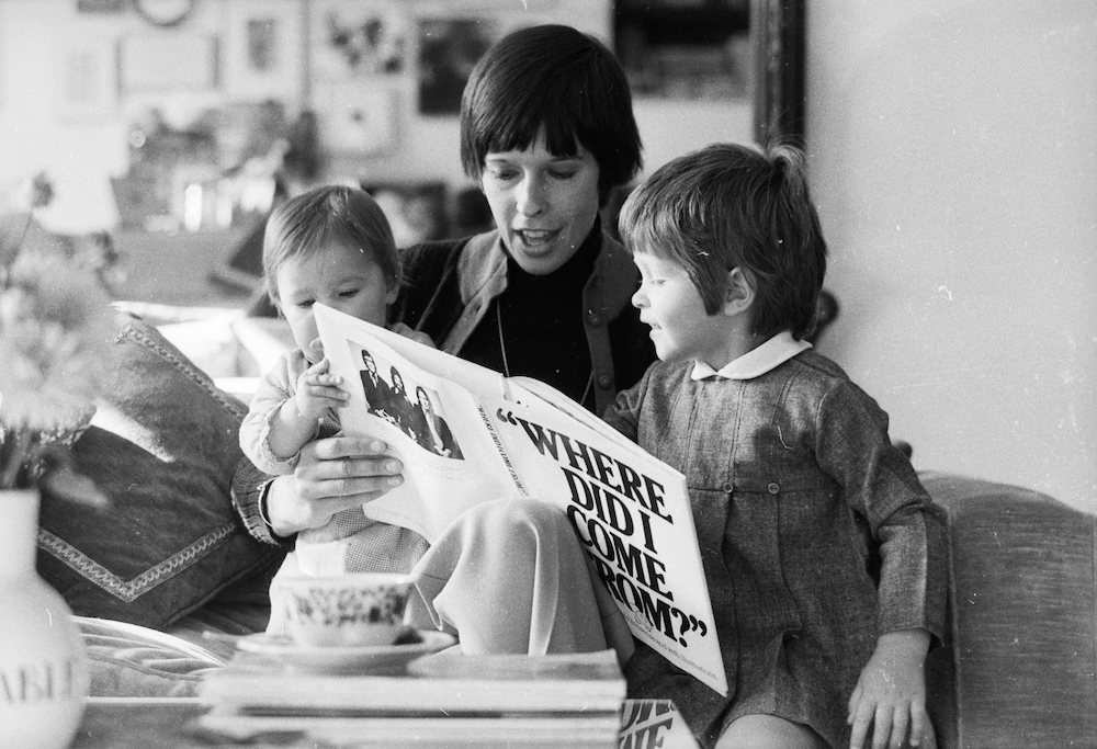 8th October 1974: Nicola Mayle reads to her two small children Jane and Joanna from a book entitled 'Where Did I Come From?'. The book was written by her husband Peter Mayle, to teach children about sex. (Photo by Michael Stroud/Express/Getty Images)