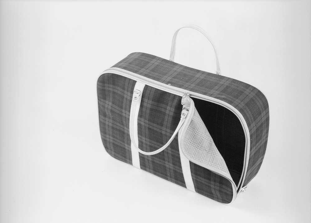 22nd June 1960: A tartan zip-up cloth suitcase for sale at John Barkers department store in London. (Photo by Chaloner Woods/Getty Images)