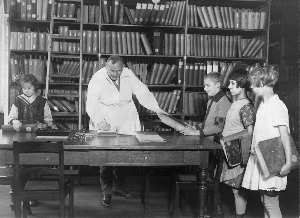 circa 1920: Blind children collecting books from the braille library at the Berlin Institute for the Blind. (Photo by Hulton Archive/Getty Images)