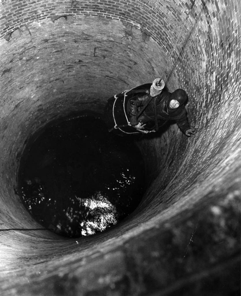 7th April 1965:  Corporal John Pearson is lowered down a well during a search by the Royal Engineers for treasure at Bosing House.  (Photo by Reg Speller/Fox Photos/Getty Images)
