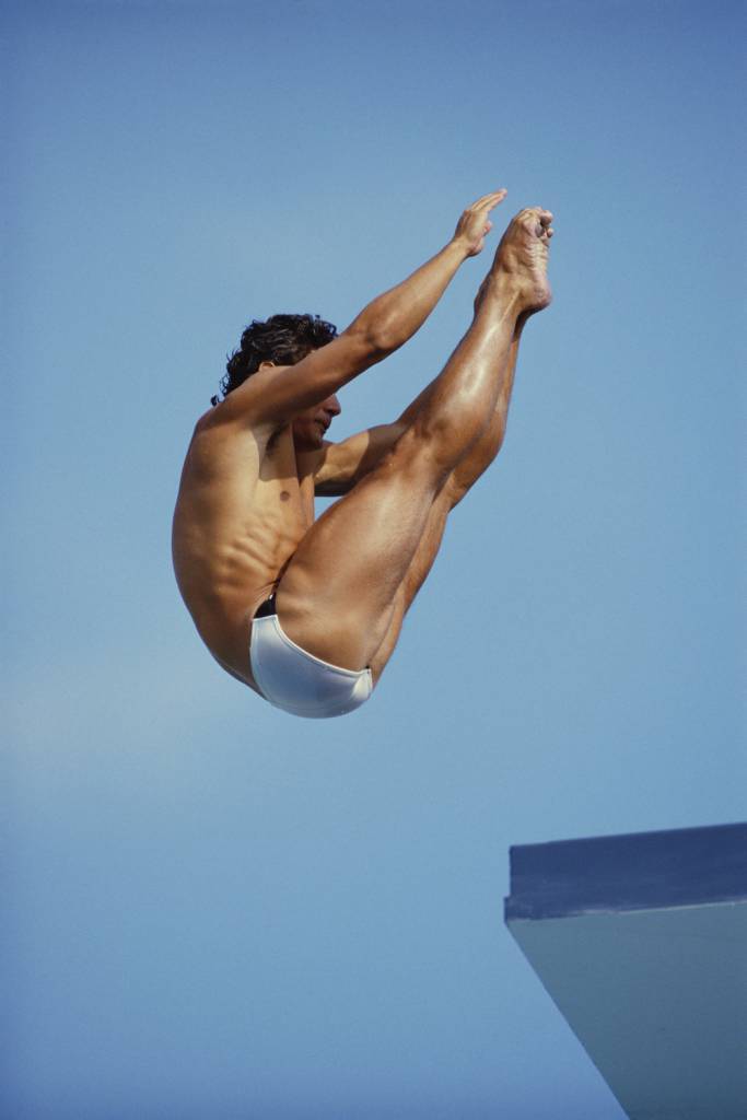 Olympic diver Greg Louganis of the United States performs a practice dive during practice for the 10-meter platform diving competition on 7th February 1987 during the U.S.National Swimming Championships in Mission Bay, Boca Raton, United States .(Photo by Bob Martin/Getty Images)