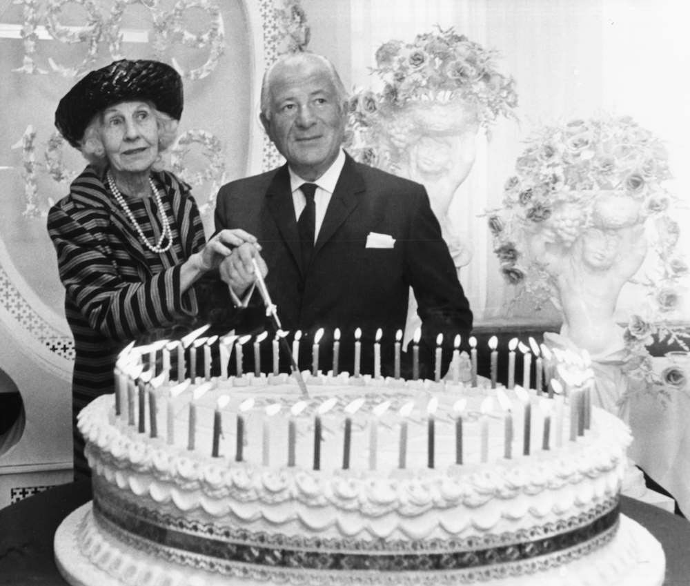 British retail and property magnate Charles Clore and department store heiress Rosalie Selfridge cutting a huge cake to mark the beginning of Selfridges Diamond jubilee, London, March 12th 1969. (Photo by Michael Webb/Keystone/Getty Images)