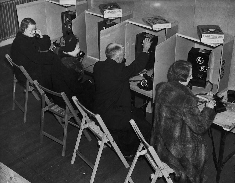 An emergency telephone bureau in Moorgate, London, 7th January 1941. The bureau is provided by the Post Office for the use of workers whose office telephones have been cut off by air raid damage. (Photo by Harry Todd/Fox Photos/Hulton Archive/Getty Images)