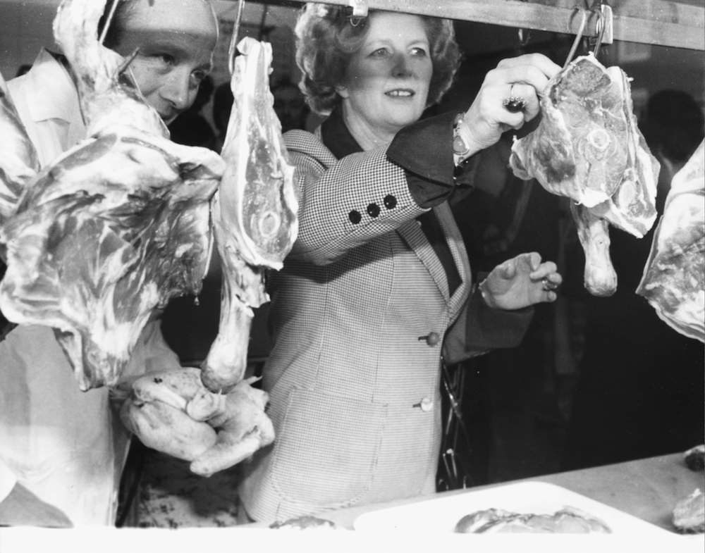 Conservative Party leader Margaret Thatcher helping out local butcher Mr Miller during canvassing for the General Election, April 7th 1979. (Photo by Ball/Keystone/Getty Images)