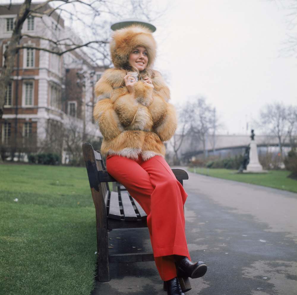 Australian pop singer Olivia Newton-John wearing a heavy fur coat outside the Savoy Hotel in London, circa 1973. (Photo by Keystone/Hulton Archive/Getty Images)