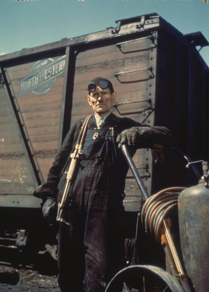 Portrait of welder Mike Evans as he poses with his equipment in the Proviso yard of the Chicago & North Western railroad, Chicago, Illinois, April 1943. (Photo by Jack Delano/Getty Images)
