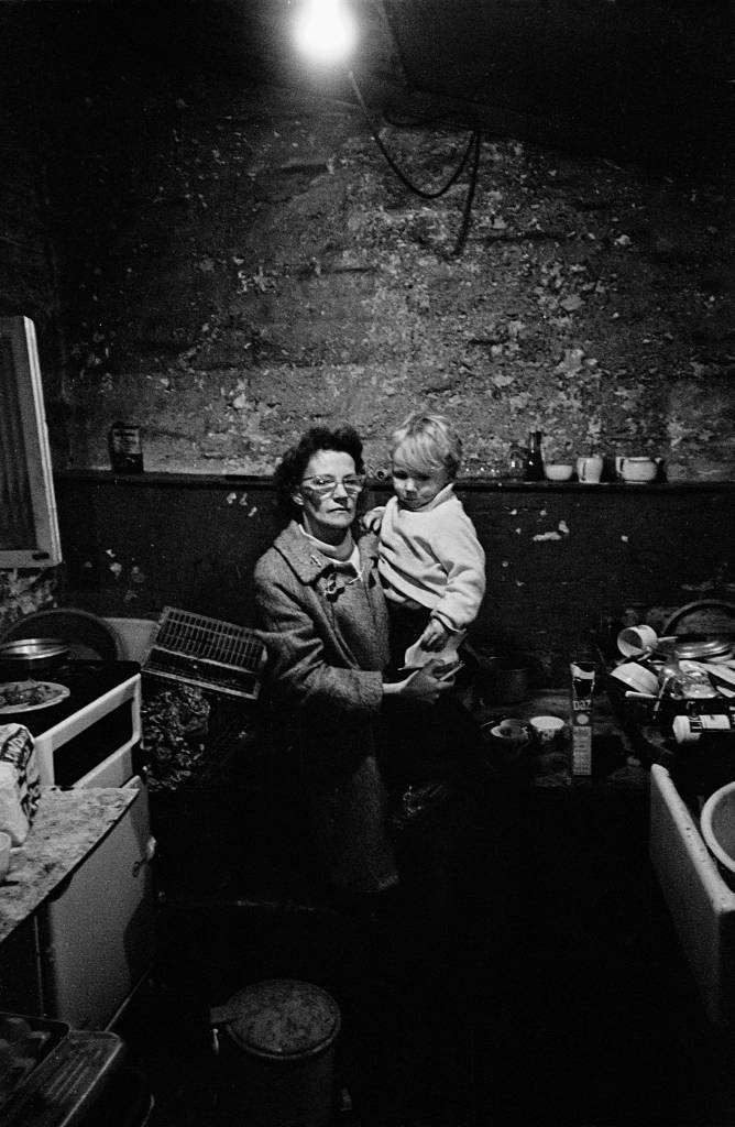 Mother and son in foul kitchen basement Battersea 1970