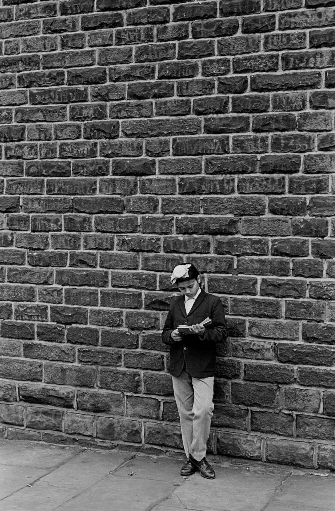 Sikh boy reading a comic, Bradford 1969