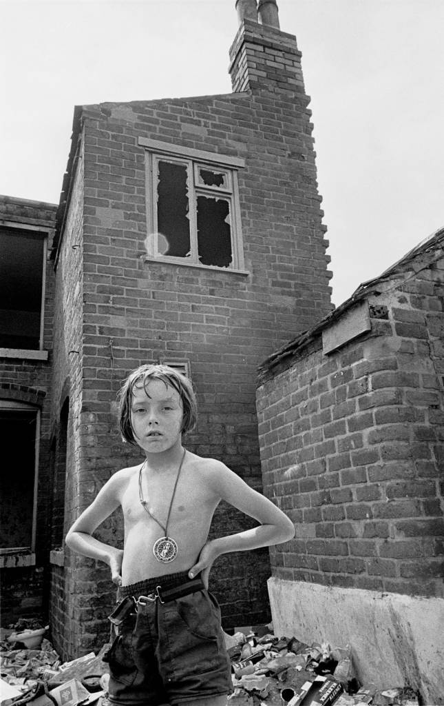 Young girl playing by derelict property 1969