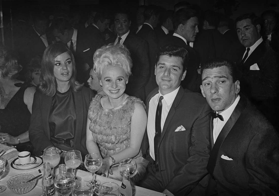 Frances Shea (1943 - 1967, far left) and her husband, English gangster Reggie Kray (1933 - 2000, far right) with actress Barbara Windsor and her husband Ronnie Knight, an associate of the Krays, at the El Morocco nightclub, owned by the Kray Twins in Soho, London, 30th April 1965. (Photo by Larry Ellis/Daily Express/Hulton Archive/Getty Images)