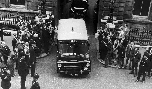 A Police van carrying Ramon George Sneyd, leaves Bow Street court in London, England on June 18, 1968, after the hearing. Ramon George Sneyd, said by American Police to be James Earl Ray, wanted for questioning in connection with the shooting of Dr. Martin Luther King, has been remanded in custody until June 27 when extradition proceedings will be heard. The hearing of the two British charges possession of a forced passport and a firearm and ammunition, without a certificate would be adjourned until the end of the extraction application.