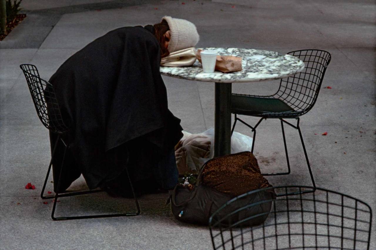 1984, New York, homeless woman asleep at a table