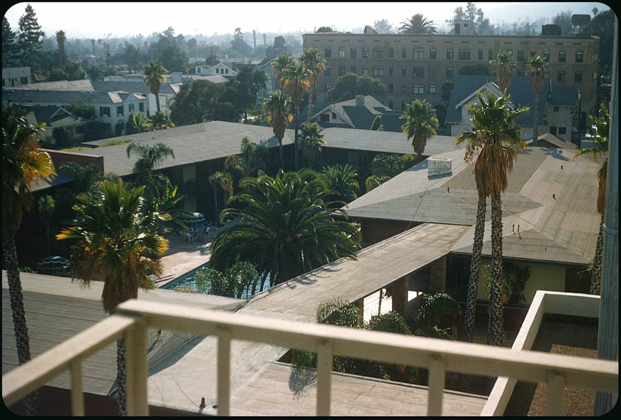Hollywood Roosevelt Hotel - 1956 An early morning mist (smog?) colors the Los Angeles skyline over the Cabanas at the hotel. Not many of the smaller buildings (one-time residences?) seen in this slide are left.
