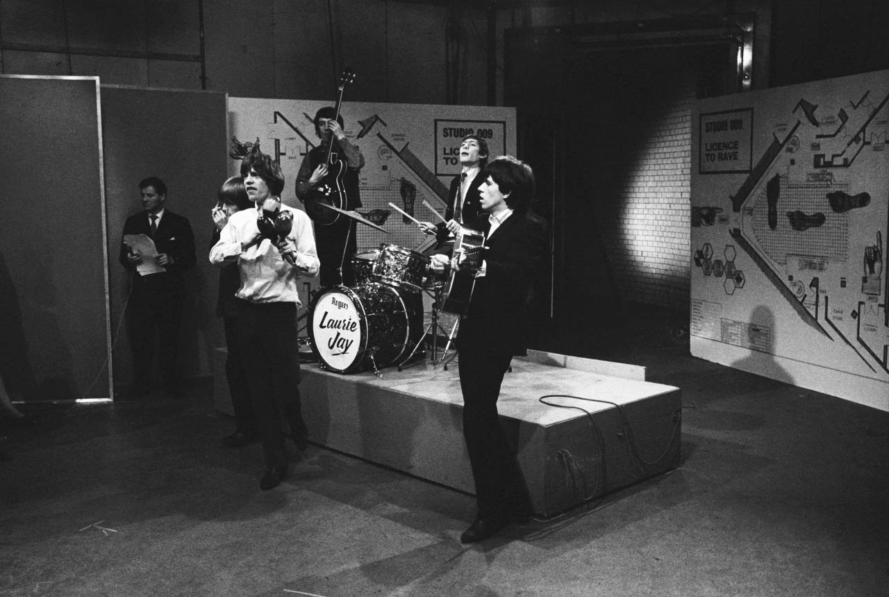 The Rolling Stones appearing on the television show 'Ready Steady Go', 14th February 1964. From left to right, Brian Jones on harmonica, Mick Jagger on maracas, bassist Bill Wyman, drummer Charlie Watts and guitarist Keith Richards. (Photo by Frank Martin/BIPS/Getty Images)