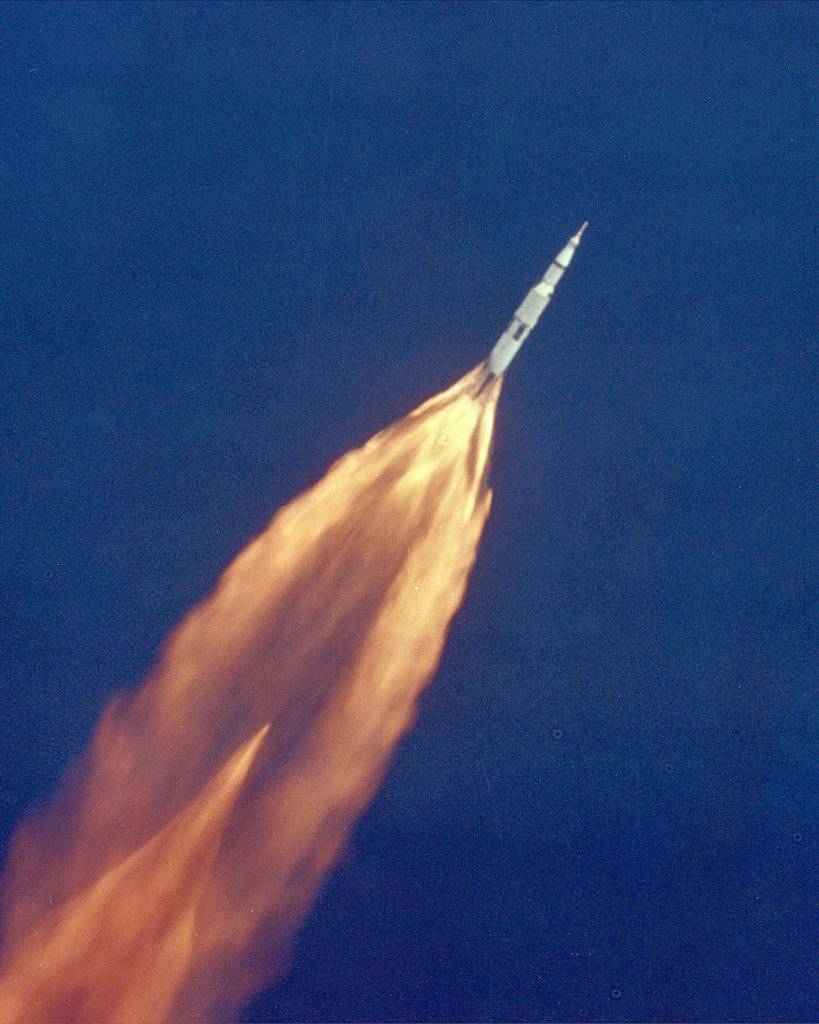 Apollo 11 Launch The Apollo 11 Saturn V space vehicle climbs toward orbit after liftoff from Pad 39A at 9:32 a.m. EDT. In 2 1/2 minutes of powered flight, the S-IC booster lifts the vehicle to an altitude of about 39 miles some 55 miles downrange. This photo was taken with a 70mm telescopic camera mounted in an Air Force EC-135N plane. Onboard are astronauts Neil A. Armstrong, Michael Collins and Edwin E. Aldrin, Jr. Date:7/16/1969 