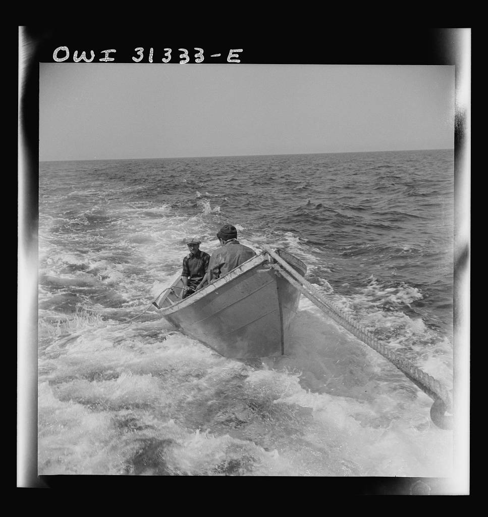 A dory with men, being towed during a mackerel chase