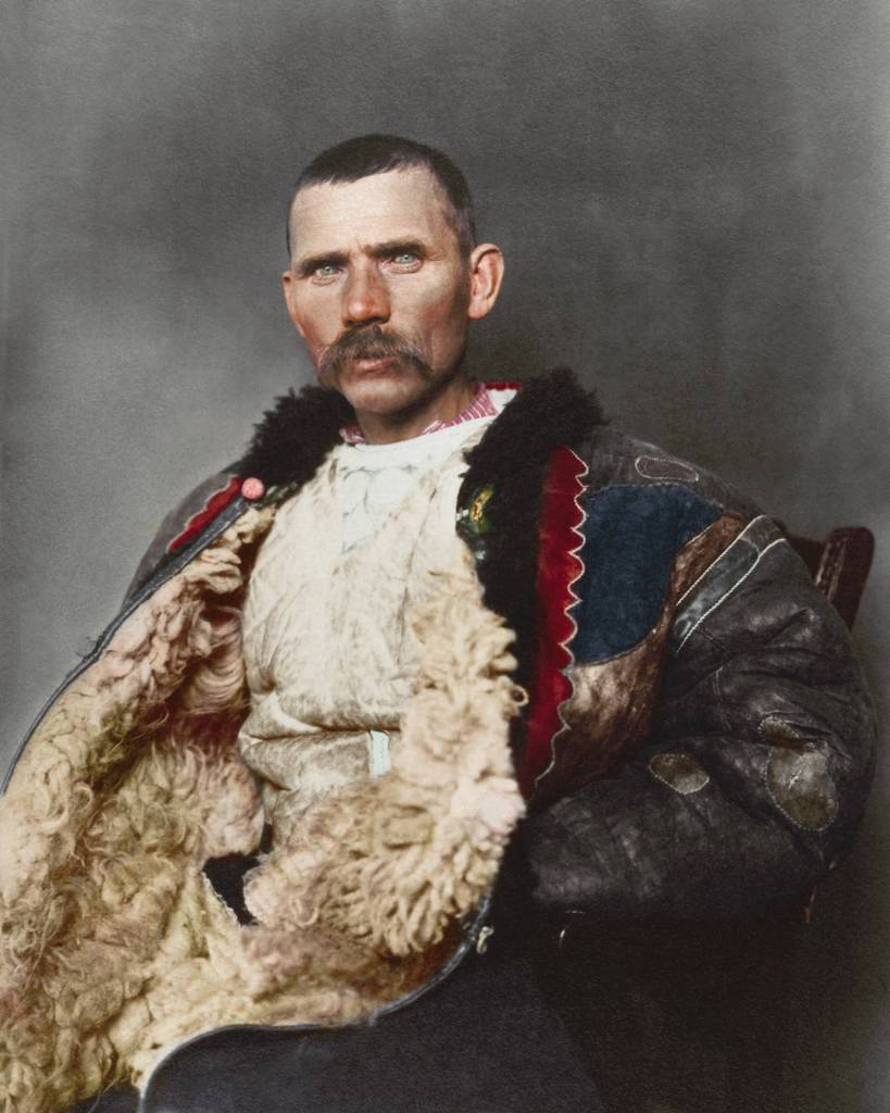 1906 "Romanian shepherd." Dominating the photograph is a traditional shepherd’s cloak known as sarică, made from three or four sheepskins sewn together with the fleece facing outwards and were generally extended to below the knee, which could be used as a pillow when sleeping outdoors. Sheepskin was also used to make the shepherd’s cojoc, an embroidered sleeved coat that had tassels, leather strips and other small decorative elements added. This particular example given the ornamentation wasn’t likely used for practical purposes given the amount of decoration adorning it.