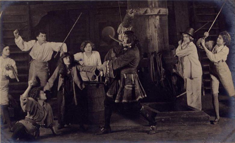 Nina Boucicault as Peter , Hilda Trevelyan as Wendy, Gerald du Maurier as Captain Hook , Pauline Chase as Twin #1 (in tophat) with the Lost Boys in the 1904 London production of Peter Pan