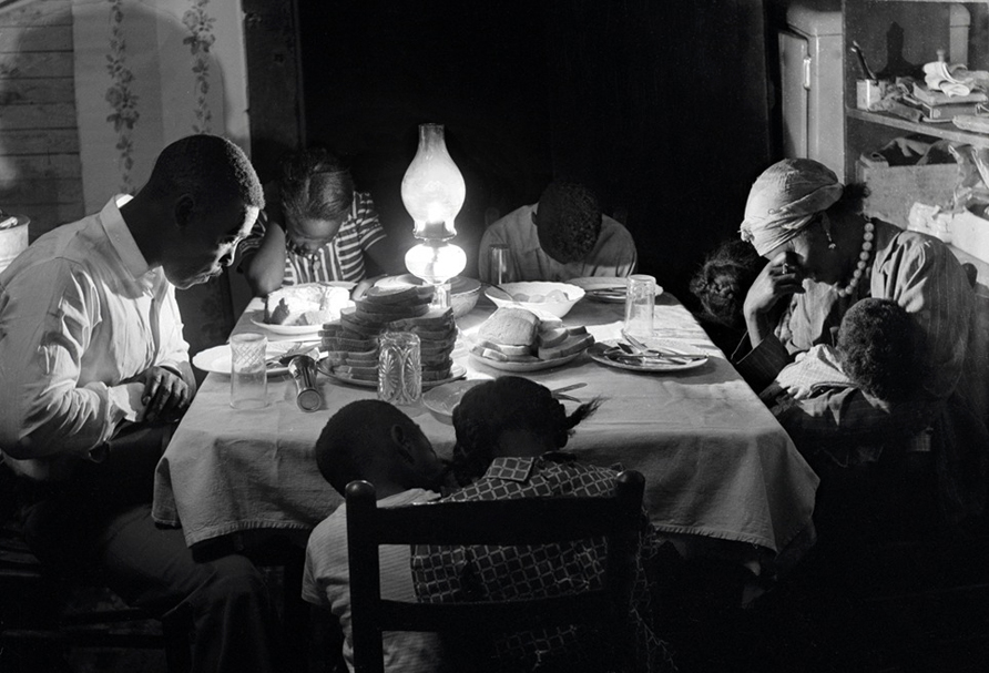 Matt Ingram, wife Linward and their children pray before dinner, Yanceyville, North Carolina, 1953.