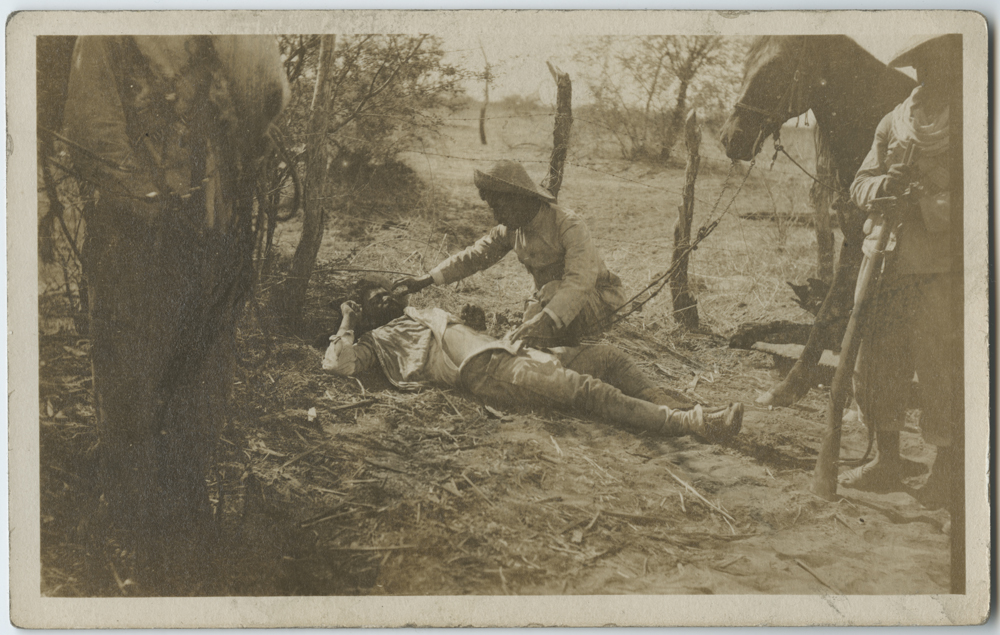 Title: [Mexican man kneeling beside dead body] Creator: Unknown Date: ca. 1910-1917