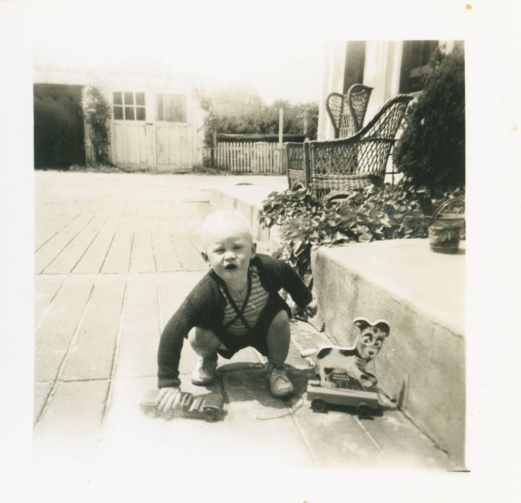 me (Ted Polhemus) playing outside, judging by the fancy chairs, maybe at my mother's parents' home in Interlaken, New Jersey, USA.