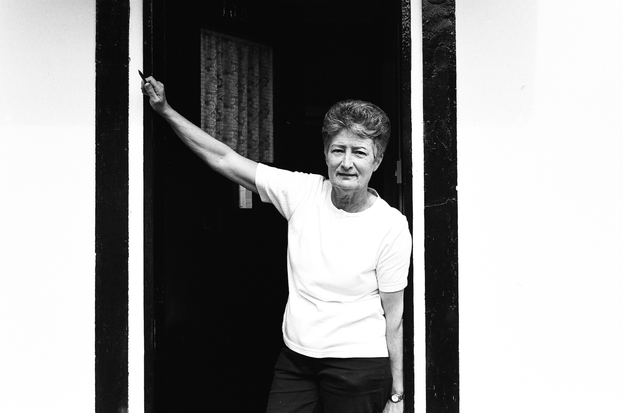 Alice outside her uni-seco Prefab in Nunhead, 2002. Post-war prefabs in Peckham, Nunhead, Dulwich, South London in 2002 and 2003