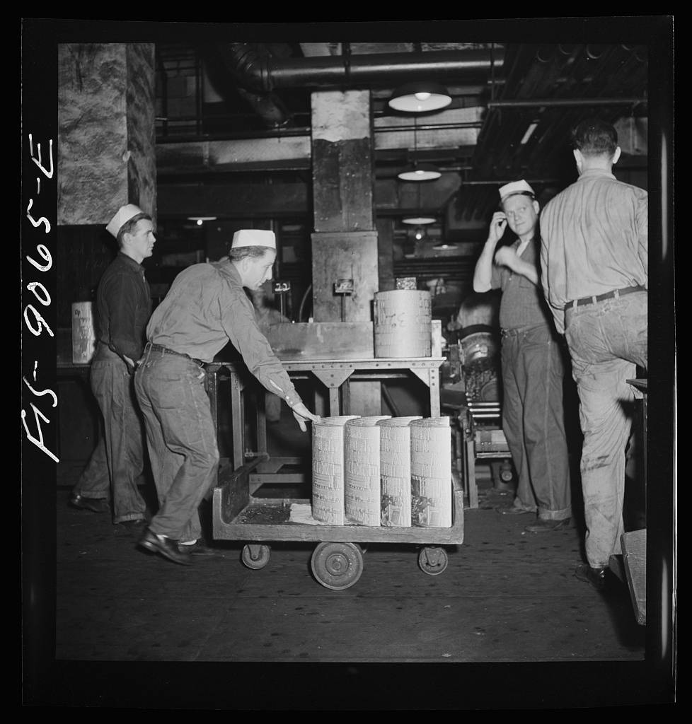 Pressroom of the New York Times newspaper. Transporting plates from shaver to presses on truck. Each plate weighs about fifty pounds, is made of lead alloy and is remelted after each printing in Autoplate