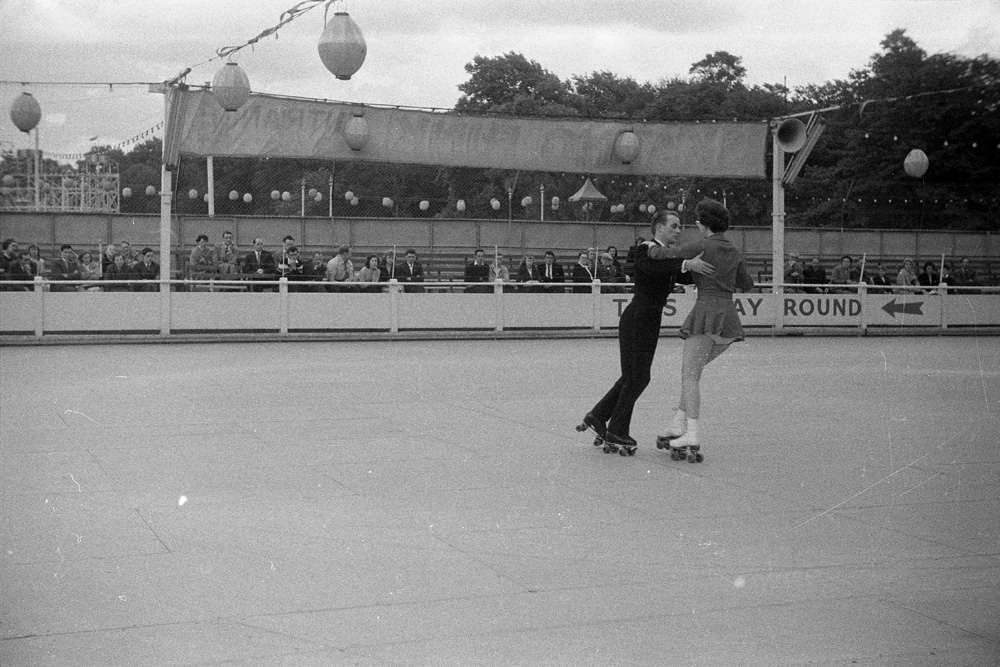 Couple on the roller skating rink in Battersea Park.