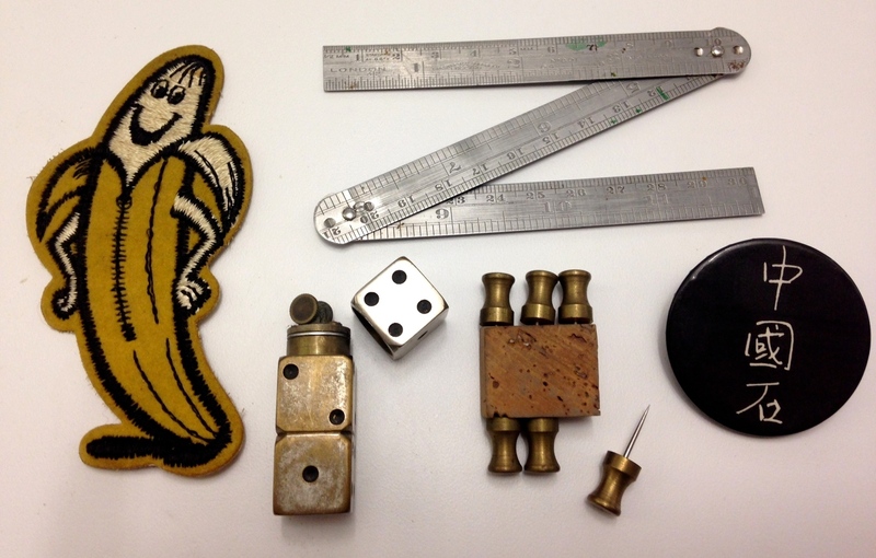 Just weird cool stuff found in a drawer, including dice-petrol lighter, heavy brass thumb-tacks, folding ruler, smiling-banana patch & a Johnny Thunders “Chinese Rocks” badge.