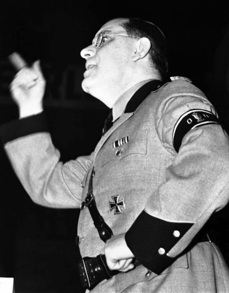 At the meeting of the German American bund held in Madison Square Garden, New York on Feb. 20, 1939,Fritz Kuhn, national leader of the Bund, uttered imprecations against the Jews. He was the concluding speaker in a Bund programme which was marked by violence, despite a police guard of hundreds. Fritz Kuhn, in full uniform of a storm trooper, delivering his bitter attack on the Jews, at the meeting of the German American Bund held in Madison Square Garden, New York on Feb. 20, 1939.