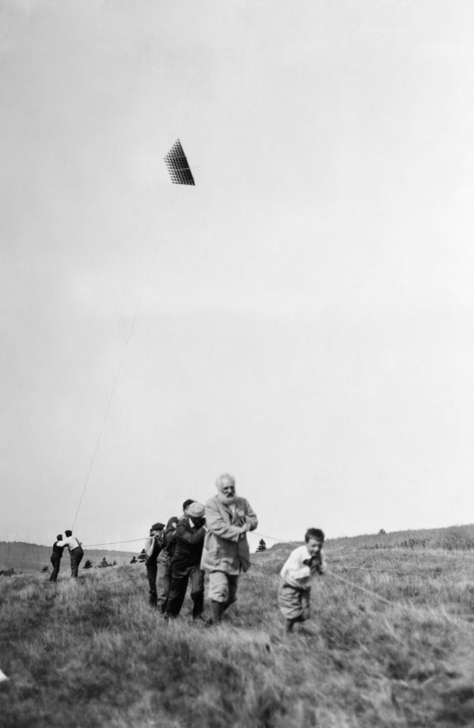 Alexander Graham Bell (1847-1922). American (Scottish-Born) Teacher And Inventor. Pulling A Rope Attached To An Experimental Tetrahedral Kite, Along With His Grandson Melville Bell Grosvenor And A Group Of Others In Baddeck, Nova Scotia. Photograph, 21 August 1908. Alexander Graham Bell