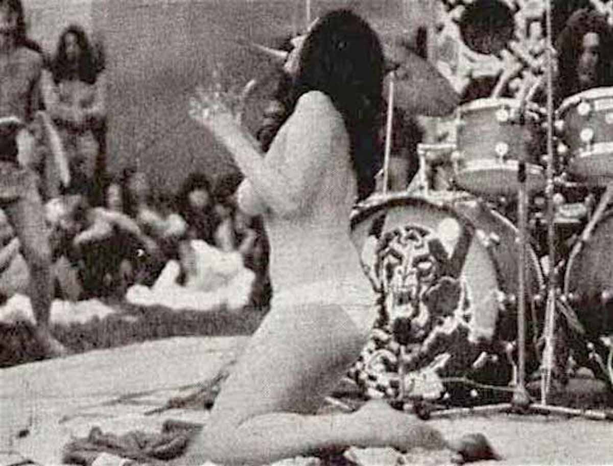 Stacia Blake performing in front of the drumhead during Hawkwind’s set at Windsor 1973. Photographer: Unknown