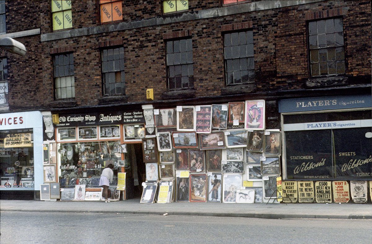 Display of posters and reproduction paintings outside the Old Curiosity Shop on Chapel Street, Salford, September 1973.
