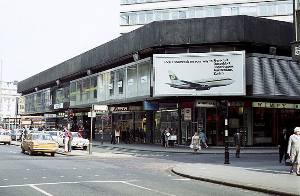 View of Mosley Street at its junction with York Street in 1972, showing shops in the podium element of the Piccadilly Plaza development.