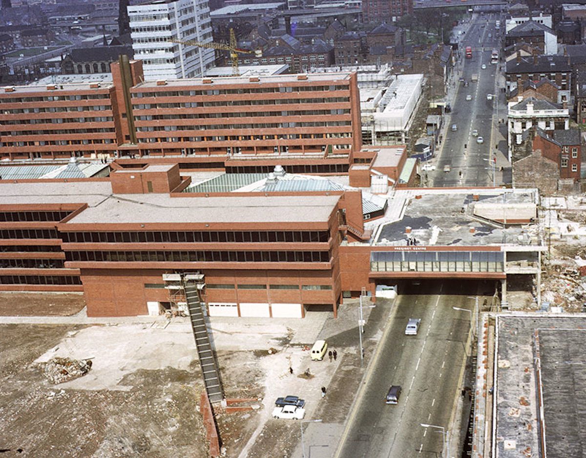 View up Oxford Road towards the city centre from the tower of the University of Manchester's Mathematics Building in 1972. The Precinct Centre (in the foreground) and the Royal Northern College of Music (beyond) are nearing completion.
