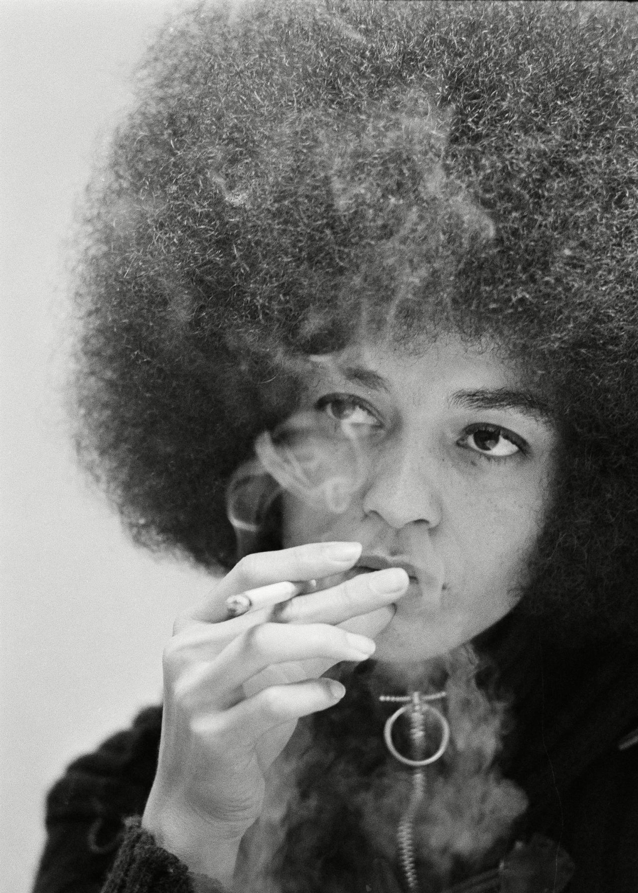 Angela Davis Angela Davis, black Communist jailed for more than a year on murder-conspiracy charges resulting from San Rafael courthouse slaying of a judge and three others, has a cigarette as she talks during an exclusive interview with Associated Press reporters Edith Lederer and Jeannine Yoemans in tiny green interview room at Santa Clara County jail at Palo Alto 27 Dec 1971